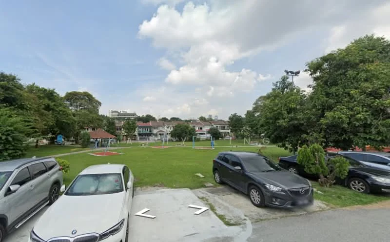 Exterior type: landscape garden; features: manicured lawn, mature trees, playground equipment, paved walkway, park benches, open green space, surrounding residential buildings, parking area; style: modern.