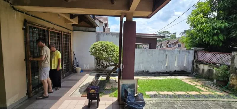 Exterior type: semi-detached house; features: manicured lawn, stone-paved walkway, garden area with shrubs, fenced yard, covered porch, sliding metal gate, exposed brick wall, roof overhang, outdoor lighting, paved driveway; style: modern.