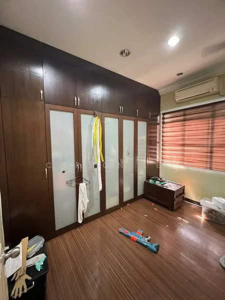 Bedroom features: built-in wardrobe with glass panels, wooden flooring, window with blinds, air conditioning unit, ceiling lights, decorative wall, cleaning supplies on the floor, wooden chest of drawers.