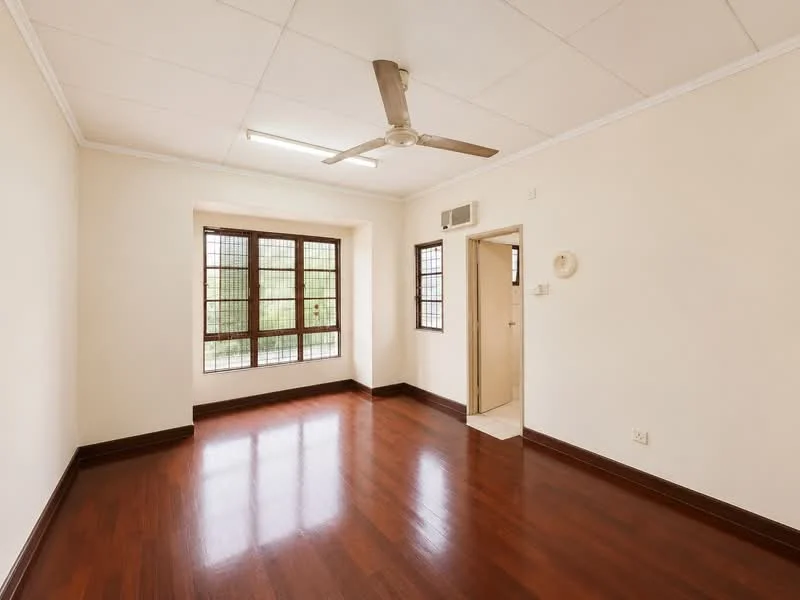 Room features: white painted walls, wooden flooring, 5-blade ceiling fan, large window with grid pattern, doorway leading to another room, light fixture on ceiling, neutral color scheme, baseboards; style: modern; view: garden.