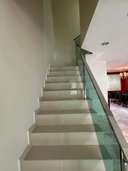 Room features: staircase with white tiled steps, glass railing, neutral painted walls, recessed ceiling lights, marble flooring at the base of the stairs; style: modern.