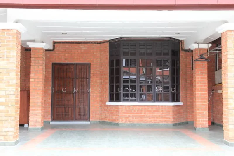 Exterior type: linked terrace house; features: red brick facade, arched window with wooden frames, double wooden door with metal grille, covered porch area, grey tiled flooring, white window sills, exposed brick walls, overhanging eaves; style: traditional.