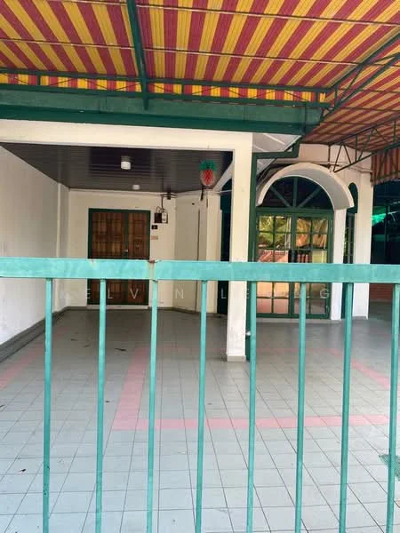 Exterior features: covered patio with striped awning, green metal railing, tiled flooring in light grey and pink, large glass doors, windows with green frames, exposed ceiling structure, interior wall with white paint, entrance door with wooden finish.