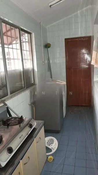 Kitchen features: white tiled walls, blue ceramic tile flooring, single-bowl stainless-steel sink, chrome faucet, freestanding gas stove, refrigerator, wooden door, window with metal grille.
