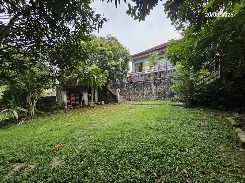 Exterior type: detached bungalow; features: manicured lawn, mature trees, stone wall, paved pathway, garden area, two-storey house, outdoor seating area, fenced perimeter; style: traditional.
