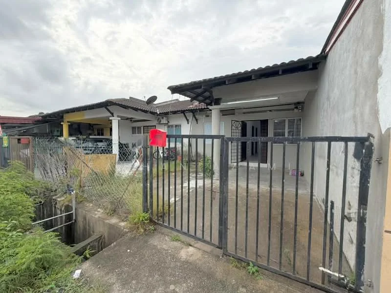 Exterior type: linked terrace house; features: gated entrance, concrete driveway, single-storey, exposed brick facade, metal gate, surrounded by greenery, roof overhang, outdoor area with concrete flooring; style: traditional.