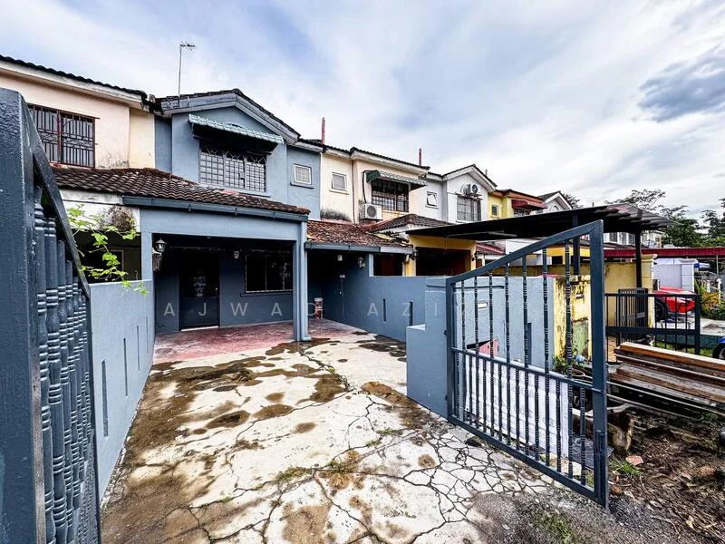 Exterior type: linked terrace house; features: grey painted facade, single-storey, manicured lawn, paved driveway, metal gate, surrounded by low walls, visible air conditioning units, roof overhang, outdoor space with concrete flooring, adjacent houses visible; style: modern.
