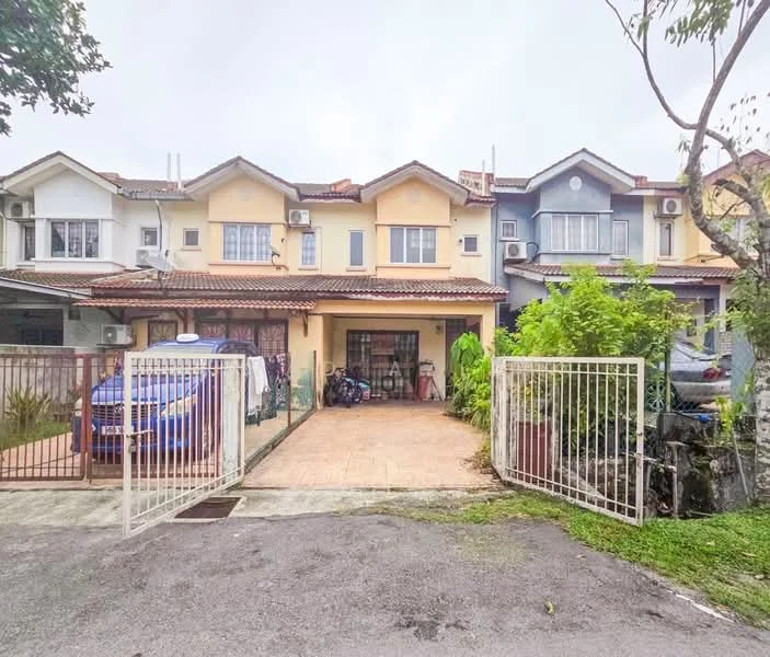 Exterior type: linked terrace house; features: two-storey building, yellow painted facade, red tiled roof, front porch with tiled flooring, gated entrance, manicured garden, multiple air conditioning units visible, parking space for one car, surrounded by greenery; style: modern.