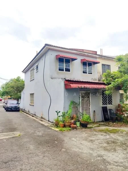 Exterior type: detached bungalow; features: two-storey building, grey painted facade, red awnings over windows, sliding windows, paved driveway, surrounded by greenery, garden area with potted plants, metal roof, side entrance, visible electrical wiring on exterior; style: traditional.