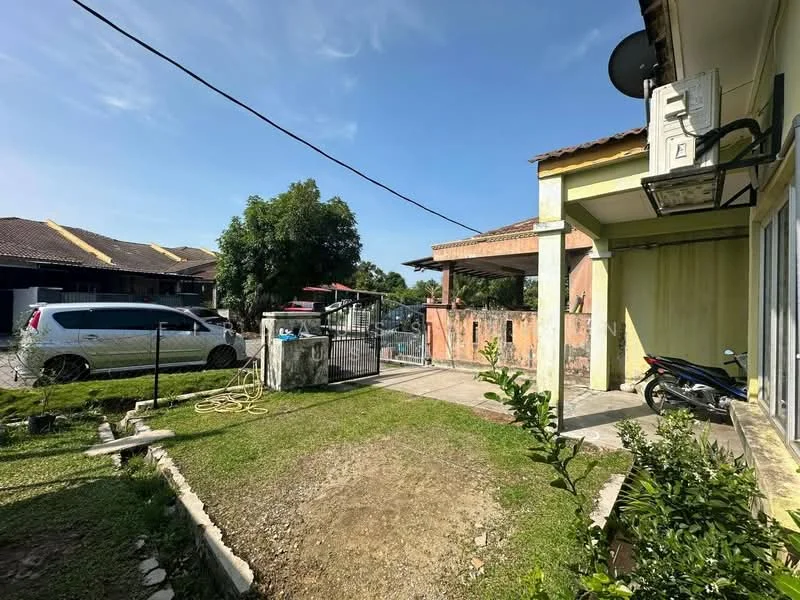 Exterior type: semi-detached house; features: manicured lawn, paved walkway, fenced perimeter, car porch, single-storey, garden area with shrubs, visible vehicle parked, outdoor air conditioning unit, gated entrance, adjacent residential buildings; style: modern.