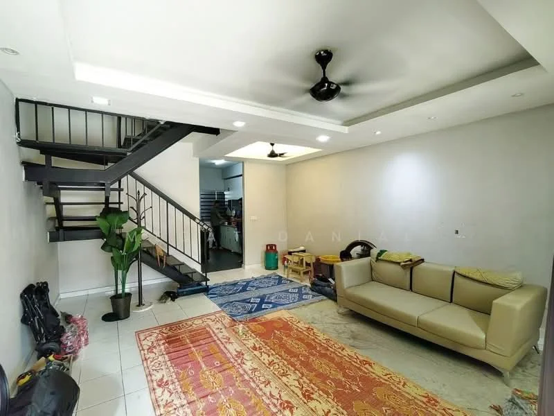 Living features: cream painted walls, white ceiling with recessed downlights, 5-blade ceiling fan, white tiled flooring, sofa in beige, area rug with geometric pattern, decorative plants in ceramic pots, staircase with black metal railing, textiles on the floor, open space layout; style: modern.