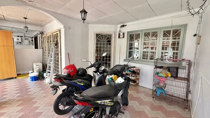 Room features: tiled flooring in beige and pink pattern, white painted walls, ceiling with exposed beams, hanging lantern light fixtures, large windows with decorative grills, two parked motorcycles, wire storage cage, open shelving with various items, utility area with cleaning supplies; style: traditional.
