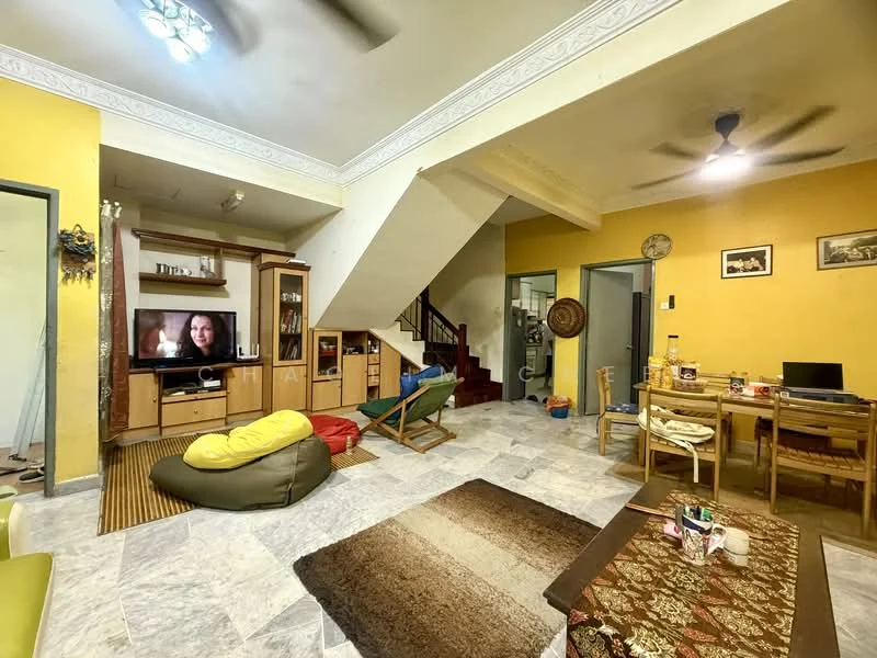 Living features: yellow painted walls, marble flooring, ceiling fan, wall-mounted TV, wooden TV cabinet, bean bag chair, wooden dining table with chairs, area rug with geometric pattern, staircase leading to upper floor, decorative wall art, open layout; style: contemporary.