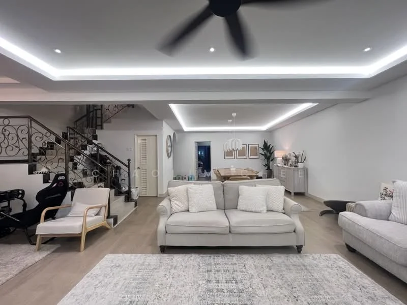 Living features: 3-seater fabric sofa in light grey, 2 accent chairs, area rug with geometric pattern, coffee table, ceiling fan with light, recessed LED downlights, wall-mounted artwork, light wood flooring, decorative plants, open layout to dining area, staircase with decorative railing; style: modern.