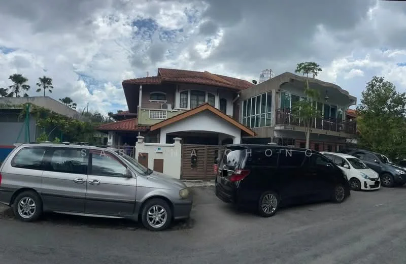 Exterior type: detached bungalow; features: two-storey building, red tiled roof, cream painted facade, balconies on upper floor, large windows, manicured garden, driveway with multiple parked cars, surrounded by greenery, paved walkway, modern architectural elements; style: contemporary.