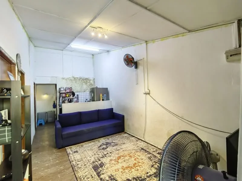 Living features: blue fabric sofa, area rug with intricate pattern, white painted walls, exposed ceiling, ceiling fan, wall-mounted air conditioning unit, wooden flooring, shelving unit, decorative wall art; style: minimalist.