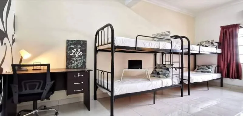 Bedroom features: bunk beds with black metal frame, single mattresses, study desk with chair, decorative wall art with the word 'Life', white walls, red curtains, tile flooring, window with natural light; style: modern.