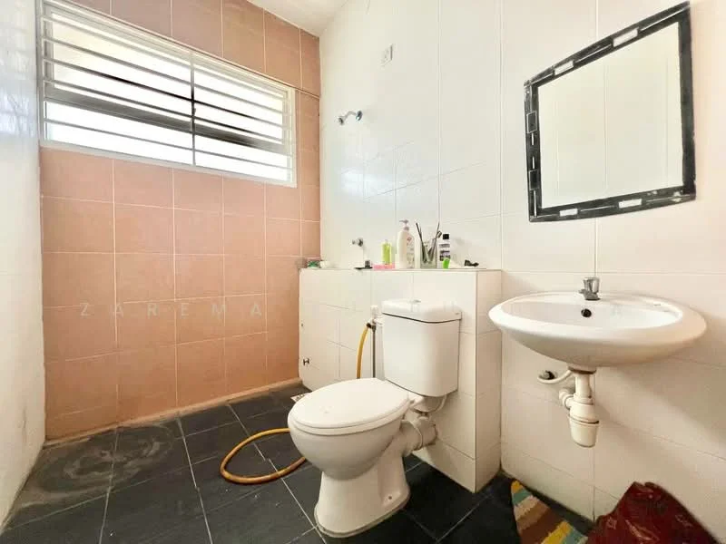 Bathroom features: pink tiled walls, white tiled walls, black floor tiles, toilet, sink with faucet, mirror, window with horizontal slats, shower area, wall-mounted toiletries shelf.