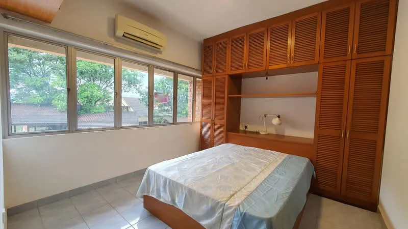 Bedroom features: queen-size bed with light blue bedding, built-in wooden wardrobe with louvered doors, desk with lamp, floor-to-ceiling windows, white painted walls, grey tiled flooring, wall-mounted split AC, natural light from windows; style: modern; view: garden.