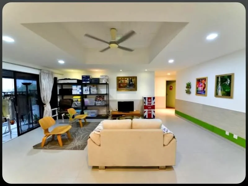 Living features: beige fabric sofa, 3-seater sofa, wooden armchair, area rug with geometric pattern, ceiling fan with light, recessed downlights, open shelving unit, decorative wall art, sliding glass door, curtains, tile flooring, green accent wall, white painted walls, wall-mounted artwork; style: modern.
