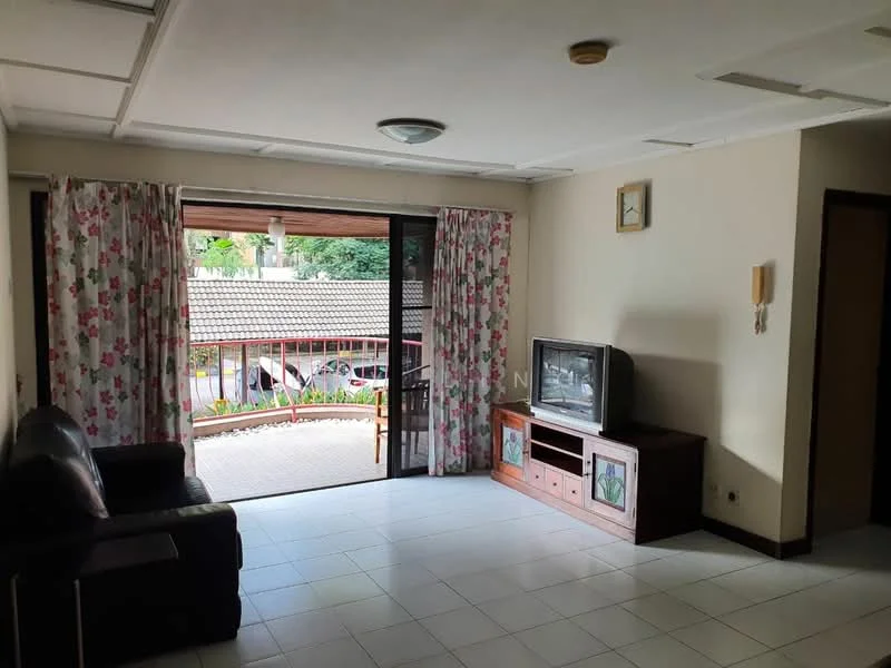 Living features: black leather sofa, wooden TV console, television, white tiled flooring, white painted walls, ceiling light fixture, curtains with floral pattern, sliding glass door, balcony view, decorative wall clock; view: garden.