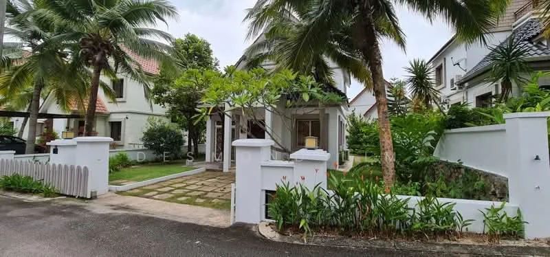 Exterior type: detached bungalow; features: white painted facade, pitched tile roof, manicured lawn, tropical landscaping, palm trees, stone-paved walkway, garden with flowering plants, covered porch, driveway with interlocking pavers; style: tropical-modern.