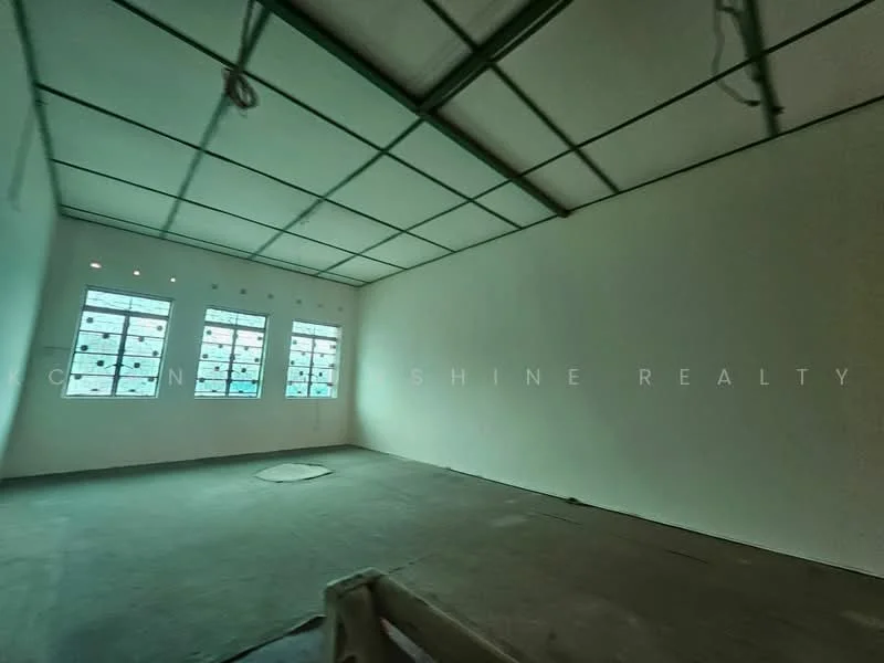Room features: white painted walls, concrete flooring, metal ceiling with grid, multiple windows, unfurnished space, no visible fixtures, circular floor drain, natural light from windows.