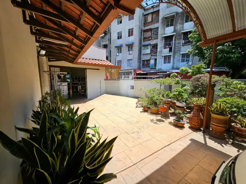Exterior features: paved outdoor area, terracotta flower pots, various potted plants, covered patio area, sloped roof with tiles, exposed wooden beams, white painted walls, surrounding greenery; style: traditional.