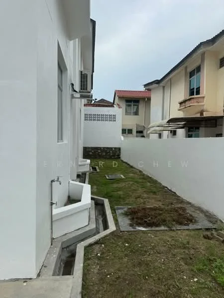 Exterior features: white painted facade, side yard, grass patch, concrete pathway, air conditioning unit, fenced perimeter, adjacent buildings.