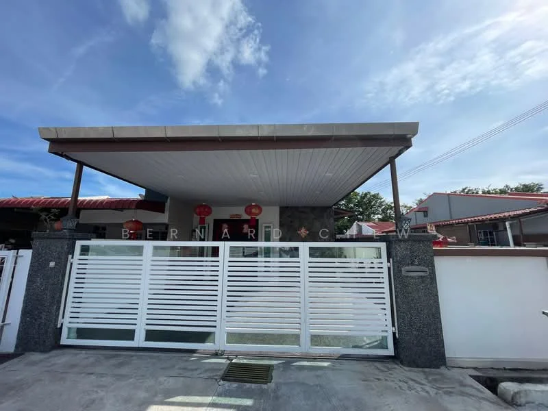 Exterior type: detached bungalow; features: grey stone facade, flat roof, white horizontal slatted gate, decorative red lanterns, manicured lawn, paved driveway, surrounded by low fencing, overhang at entrance; style: modern.