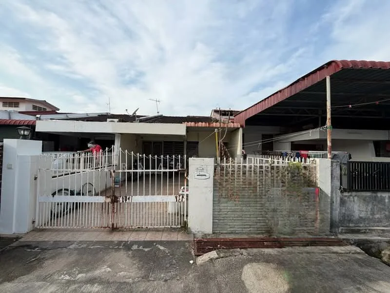 Exterior type: linked terrace house; features: white painted facade, red pitched roof, metal gate, concrete fence, driveway, outdoor parking space, front yard with grass, visible antennas on roof, covered car porch, surrounded by residential buildings; style: traditional.
