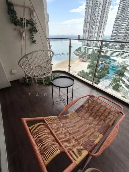 Balcony features: hanging macrame chair, woven lounge chair, small round table, glass railing, wooden flooring, view of beach, city skyline in background, decorative plant on wall; style: modern; view: sea.