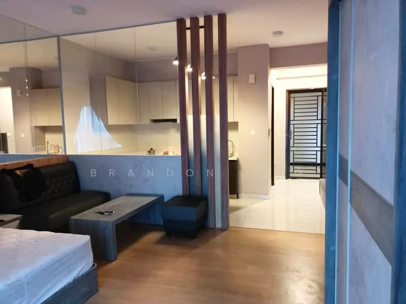 Living features: wooden flooring, grey accent wall, sofa with cushions, coffee table, wall-mounted TV, open kitchen with cabinetry, recessed downlights, floor-to-ceiling windows, decorative partition with wooden slats; style: modern. Room features: white painted walls, doorway leading to hallway, light-colored cabinetry in kitchen.