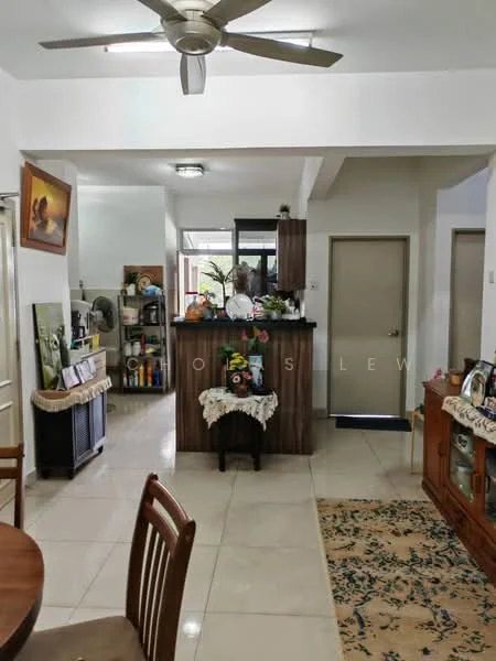 Room features: white painted walls, cream tiled flooring, ceiling fan, recessed lighting, wooden dining table, wooden dining chairs, decorative rug, wooden sideboard, open kitchen counter, kitchen cabinets, kitchen appliances visible, decorative wall art, potted plants, doorway to another room; style: modern.