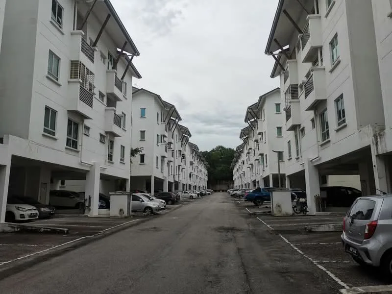 Exterior type: low-rise apartment block; features: white painted facade, flat roof, 2-storey building, covered parking, open-air parking lot, manicured landscaping, surrounded by greenery; style: modern.