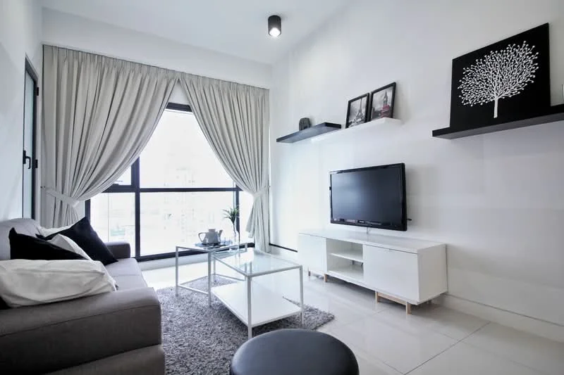 Living features: grey fabric sofa, white coffee table, black TV console, wall-mounted TV, area rug with geometric pattern, floor-to-ceiling windows, sheer curtains, black wall art, decorative shelf, potted plant; style: modern; view: city.
