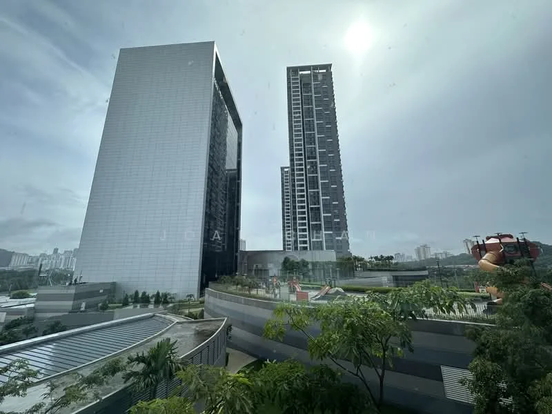 Exterior type: high-rise condominium; features: glass curtain wall facade, approximately 20-storey high-rise, surrounded by mature greenery, outdoor amenities visible, modern architectural design, multiple balconies, landscaped garden area, urban context with skyline view in background; style: modern.