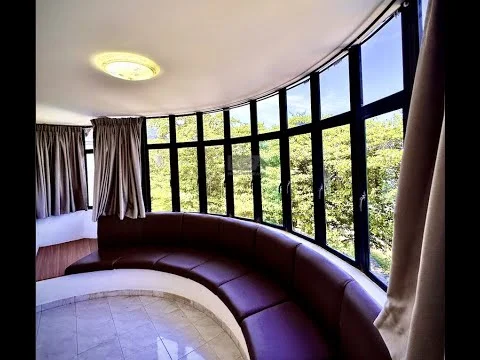 Room features: curved brown leather seating, large floor-to-ceiling windows, sheer curtains, white painted walls, marble tile flooring, ceiling light fixture, view of greenery outside; style: modern; view: garden.