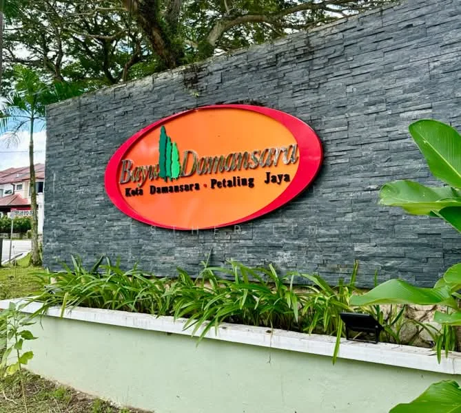 Exterior features: stone cladding on wall, landscaped garden with plants, signage with logo, greenery surrounding the area; style: modern.