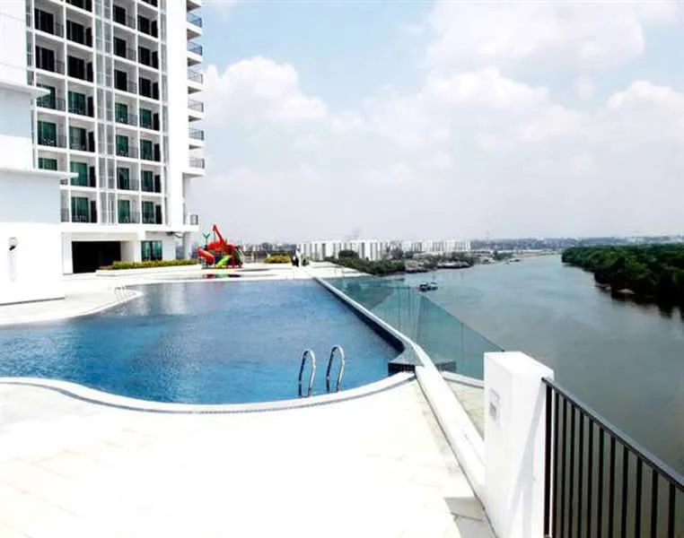 Exterior type: high-rise condominium; features: infinity pool, pool deck with loungers, glass railing, landscape view of river, surrounding greenery, modern architectural design, white painted facade, large windows, outdoor seating area; style: modern.