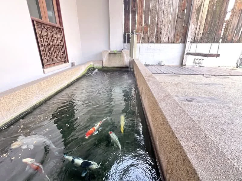 Room features: water feature with koi fish, stone-lined pond, wooden deck, swing seat, exposed wooden fence, smooth concrete edges; style: modern; view: garden.