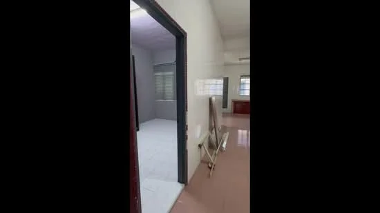 Room features: white painted walls, tile flooring, window with blinds, door frame, light fixture, open space, neutral color scheme.