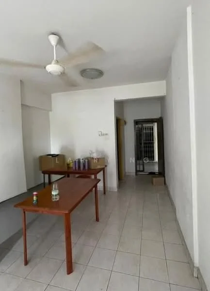 Room features: white painted walls, ceiling fan, tile flooring, two wooden tables, boxes on the floor, doorway leading to another room, window with no visible treatment, light fixture on ceiling.