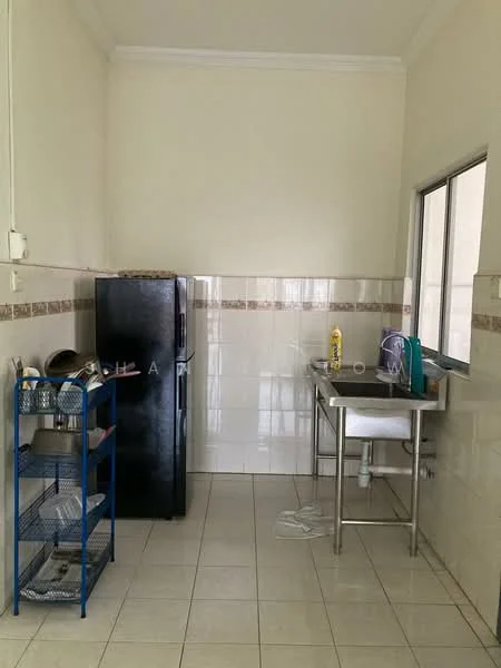 Kitchen features: black fridge, stainless-steel sink, chrome faucet, white tiled walls, cream tiled backsplash, white ceramic floor tiles, metal shelving unit, window with grid, dish rack, cleaning supplies on counter.