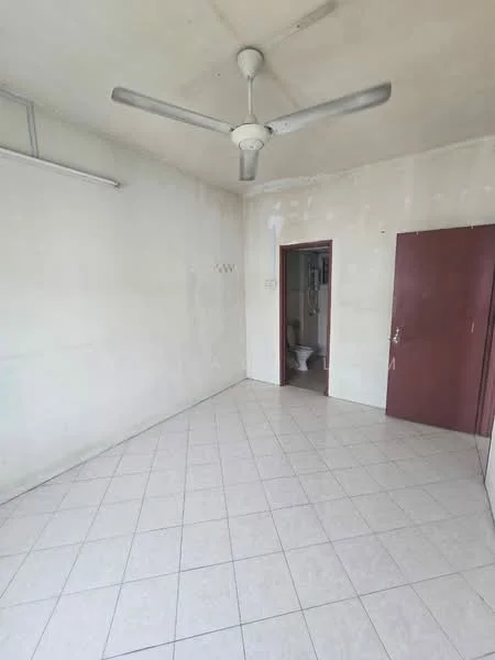 Room features: white painted walls, ceiling fan, tile flooring, single door, doorway leading to bathroom, hooks on wall, no visible furniture, neutral color scheme.