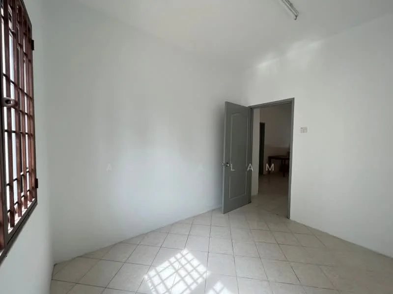 Room features: white painted walls, tile flooring, single door, window with security bars, natural light from window, ceiling light fixture.