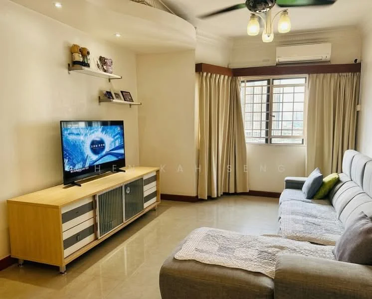 Living features: 3-seater fabric sofa in grey, wooden TV console with sliding doors, wall-mounted TV, recessed ceiling lights, ceiling fan, large window with sheer curtains, decorative shelf with items, cream painted walls, glossy tile flooring, air conditioning unit; style: modern; view: city.