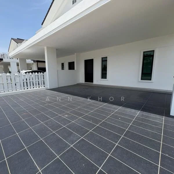 Exterior type: detached bungalow; features: white painted facade, flat roof, grey tiled flooring, fenced area with white picket fence, large outdoor patio space, multiple windows, open layout, surrounded by greenery; style: modern.