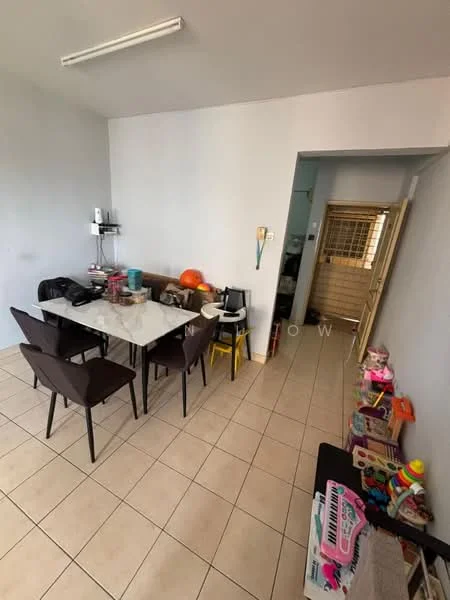 Dining features: white painted walls, tile flooring, rectangular dining table, 4 brown upholstered dining chairs, shelves with kitchenware, doorway leading to another room, toys and storage boxes on the floor, kitchen area visible in the background.