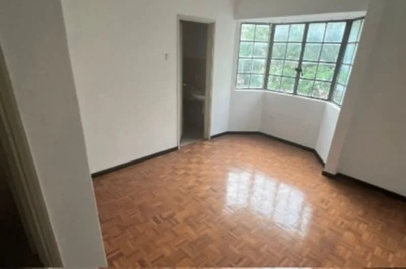 Room features: parquet wood flooring, white painted walls, large windows with multiple panes, corner window, doorway leading to another room, natural light, no visible furniture; view: garden.